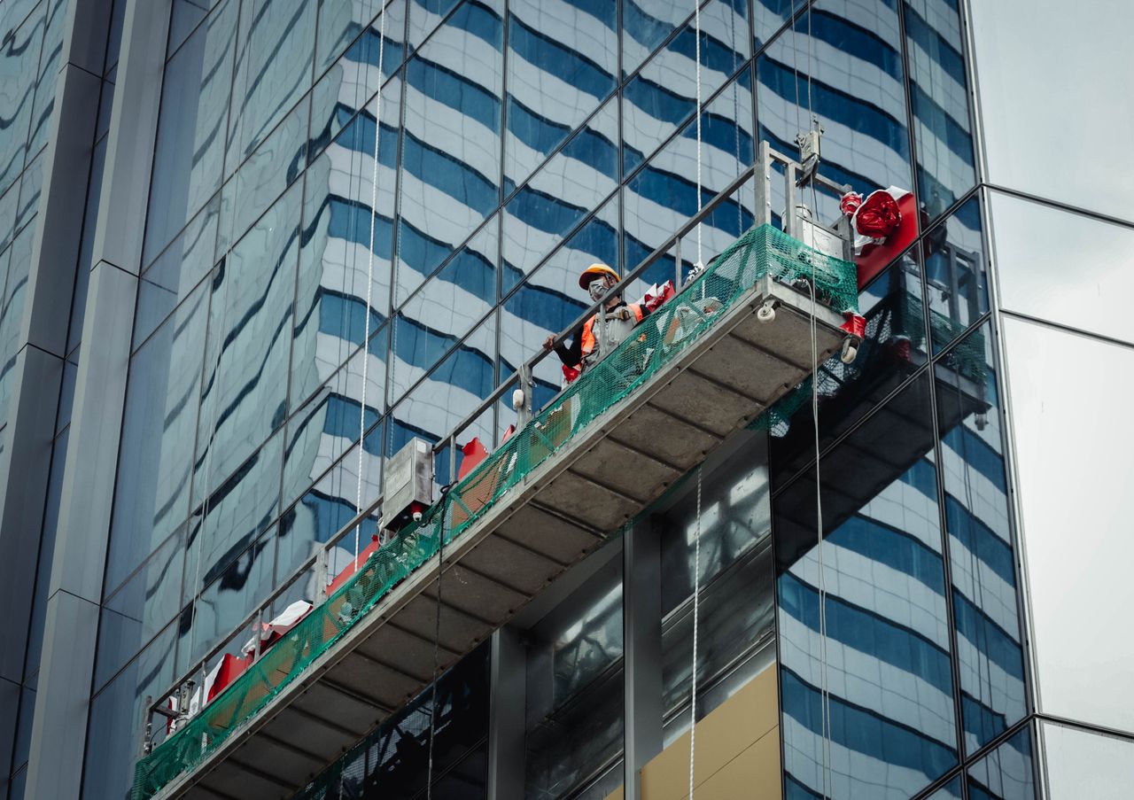 hero-img-02 Urban worker cleaning windows on a high-rise in Ho Chi Minh City, Vietnam.